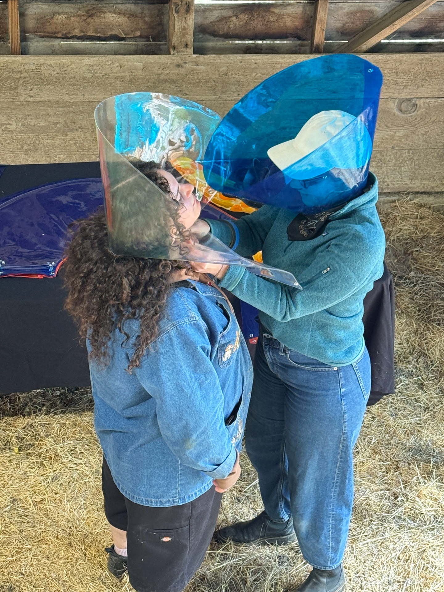 Two people wearing handmade blue masks